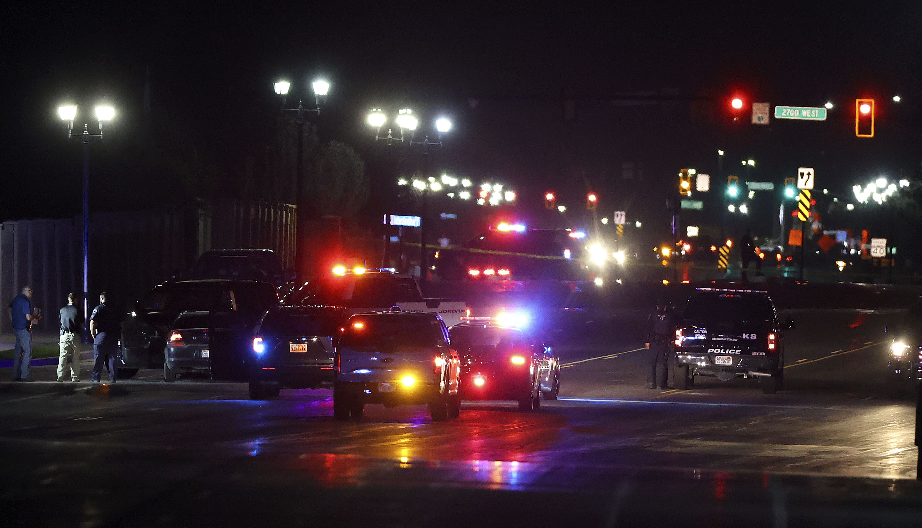 Police work at the scene of a crash, involving a driver who had just been shot, on the South Jordan Parkway in South Jordan on Sept. 27. Two men accused of chasing two women in the car and firing multiple rounds at them, striking one woman twice, have been charged.