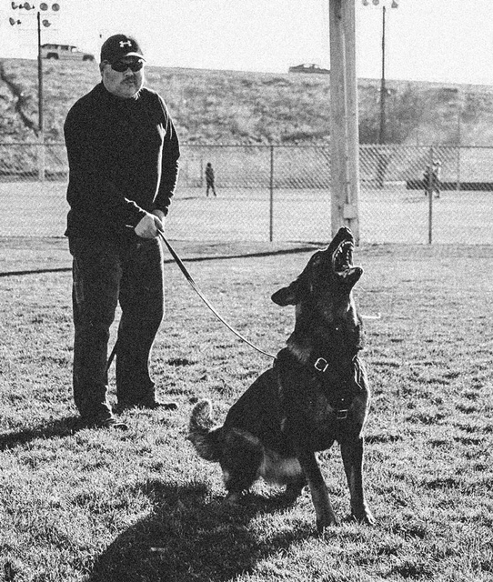 Dustin Draper with a K9 named Helo.