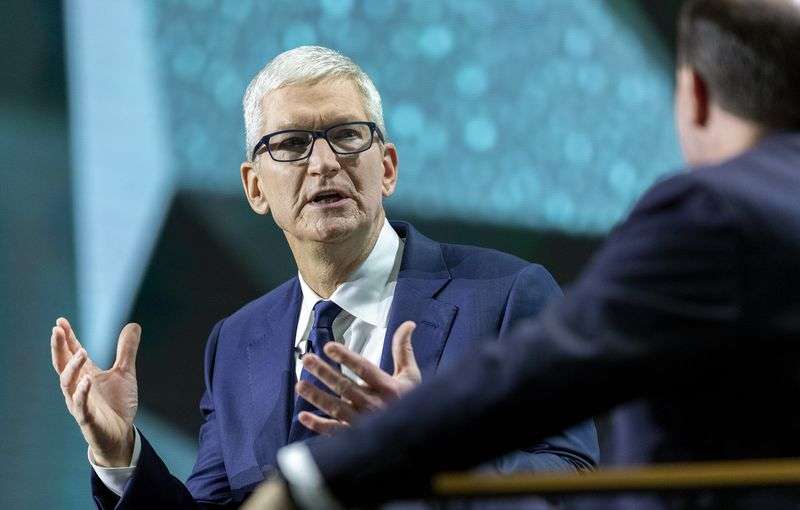 Apple CEO Tim Cook, left, talks with Sen. Mike Lee,
R-Utah, during the Silicon Slopes Summit at the Salt Palace in Salt
Lake City on Wednesday.