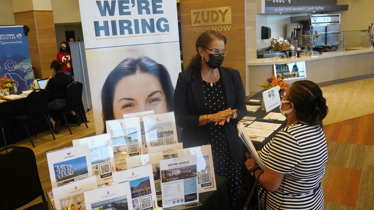Marriott human resources recruiter Mariela Cuevas, left, talks to Lisbet Oliveros, during a job fair at Hard Rock Stadium, Sept. 3, in Miami Gardens, Fla. The number of Americans seeking unemployment benefits moved up last week to 332,000 from a pandemic low, a sign that worsening COVID-19 infections may have slightly increased layoffs.