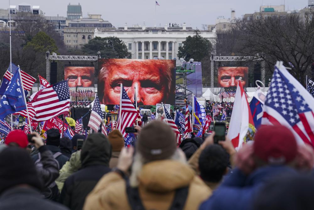 In this Jan. 6, 2021 photo, the face of President Donald Trump appears on large screens as supporters participate in a rally in Washington. The House committee investigating the violent Jan. 6 Capitol insurrection, with its latest round of subpoenas in September 2021, may uncover the degree to which former President Donald Trump, his campaign and White House were involved in planning the rally that preceded the riot, which had been billed as a grassroots demonstration.