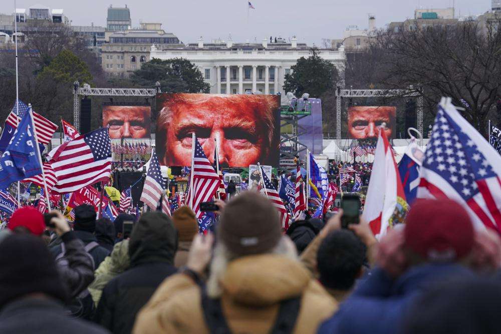In this Jan. 6, 2021 photo, the face of President Donald Trump appears on large screens as supporters participate in a rally in Washington. The House committee investigating the violent Jan. 6 Capitol insurrection, with its latest round of subpoenas in September 2021, may uncover the degree to which former President Donald Trump, his campaign and White House were involved in planning the rally that preceded the riot, which had been billed as a grassroots demonstration.