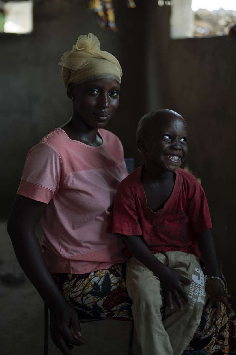 Lama Mballow poses for the photo with her 4-year-old son Ebrima in their house at the Sare Gibel village in Bansang, Gambia, Wednesday, Sept. 29, 2021.
