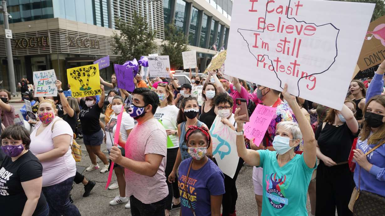 People participate in the Houston Women's March against Texas abortion ban walk from Discovery Green to City Hall in Houston on Oct. 2. A federal appeals court is temporarily allowing the nation’s toughest abortion law to resume in Texas. The 5th U.S. Circuit Court of Appeals handed down the order Friday, Oct. 8.