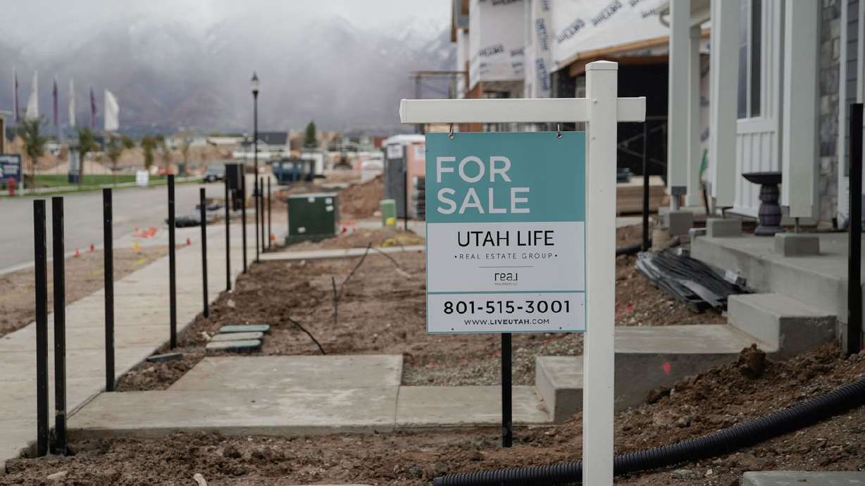 A "for sale” sign is displayed outside of a house in
Layton on Thursday.