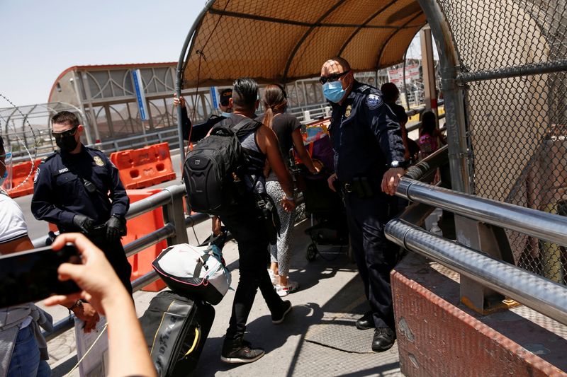 Eduardo Torobo and Amelin Acosta, migrants from Cuba under the Migrant Protection Protocols program, walk after crossing from Mexico into the U.S. to continue their asylum request in the United States in Ciudad Juarez, Mexico June 18.