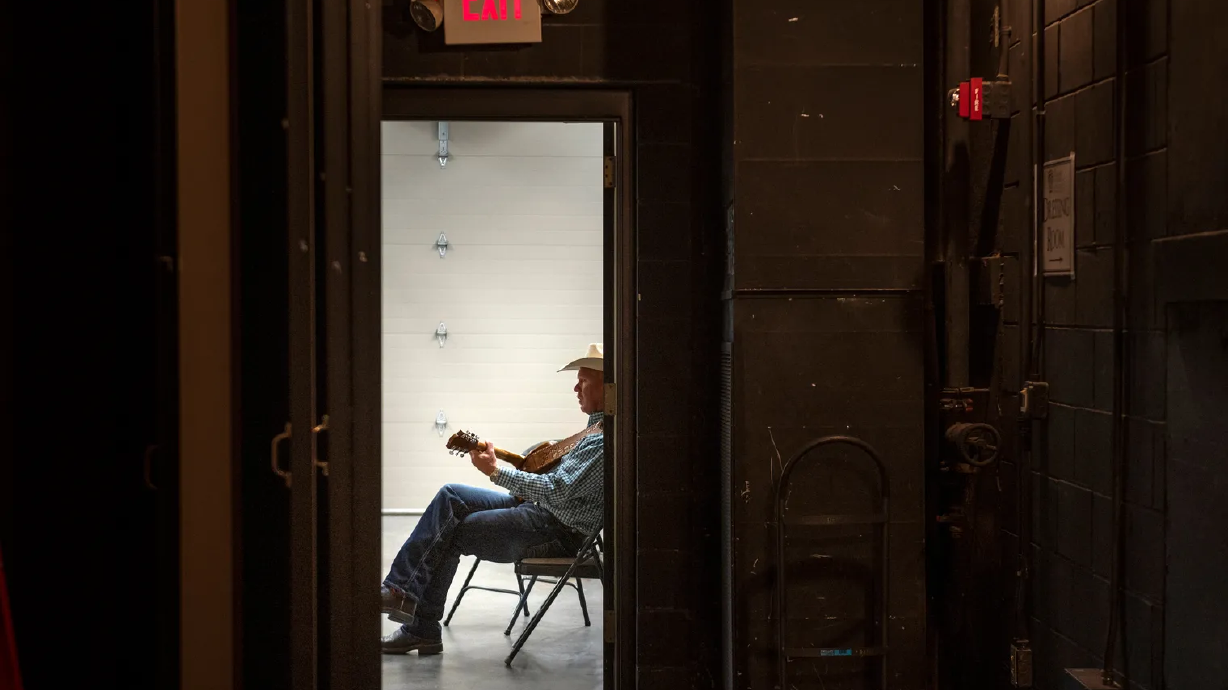 Bar J Wranglers musician Danny Rogers warms up backstage before a show in Kearney, Neb., on Oct. 7, 2021.