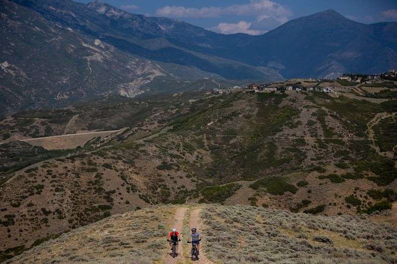 Draper Mayor Troy Walker and City Manager David Dobbins
pedal beside each other while taking journalists on a mountain
biking tour of the city’s Corner Canyon trail network on Wednesday,
Aug. 25, 2021.