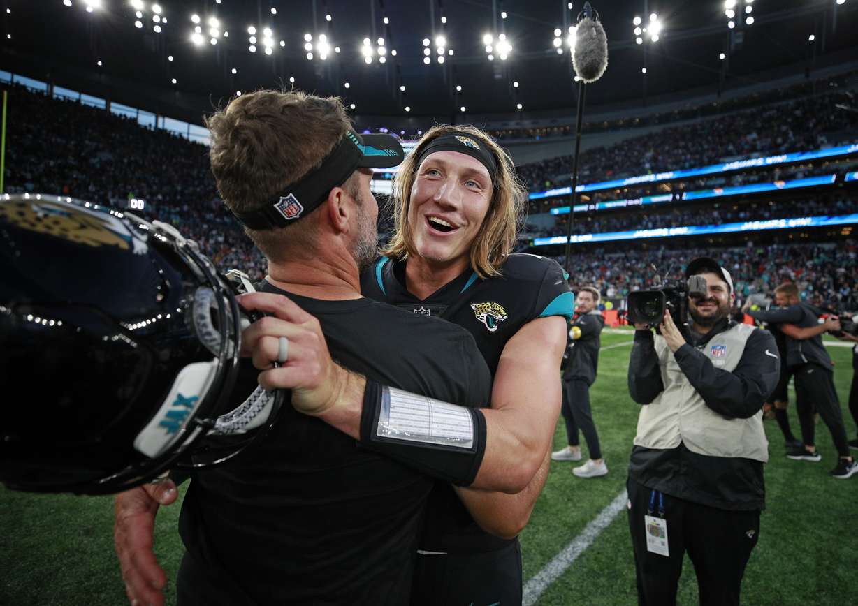 Jacksonville Jaguars quarterback Trevor Lawrence (16) celebrates on the field after an NFL football game between the Miami Dolphins and the Jacksonville Jaguars at the Tottenham Hotspur stadium in London, England, Sunday, Oct. 17, 2021. The Jaguars won the match 23-20.
