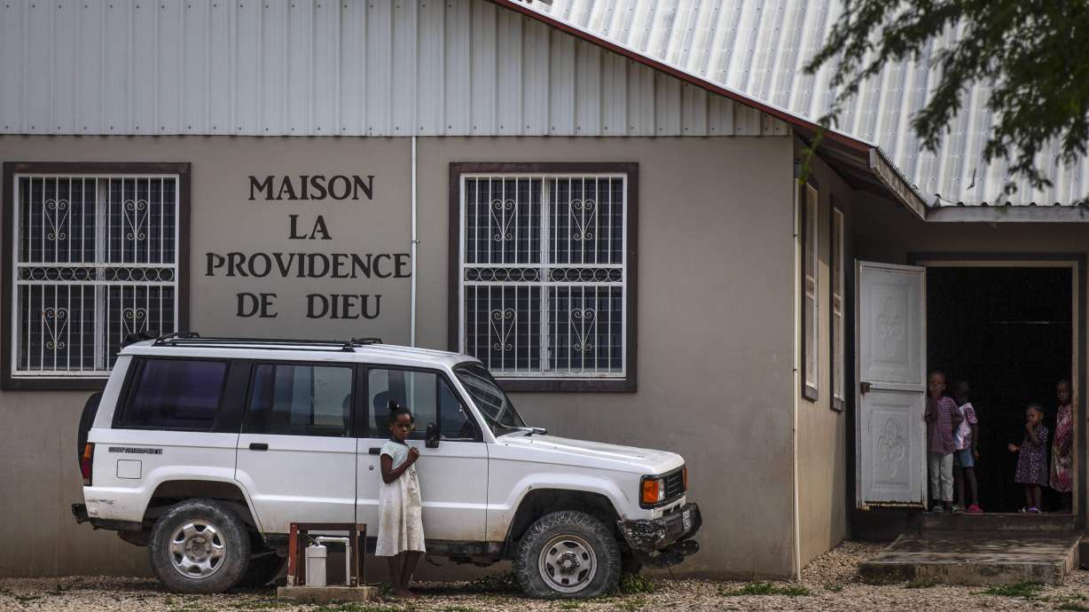 Children stand in the courtyard of the Maison La Providence de Dieu orphanage it Ganthier, Croix-des-Bouquets, Haiti, Sunday, where a gang abducted 17 missionaries from a U.S.-based organization. The 400 Mawozo gang, notorious for brazen kidnappings and killings took the group of 16 U.S. citizens and one Canadian, after a trip to visit the orphanage.