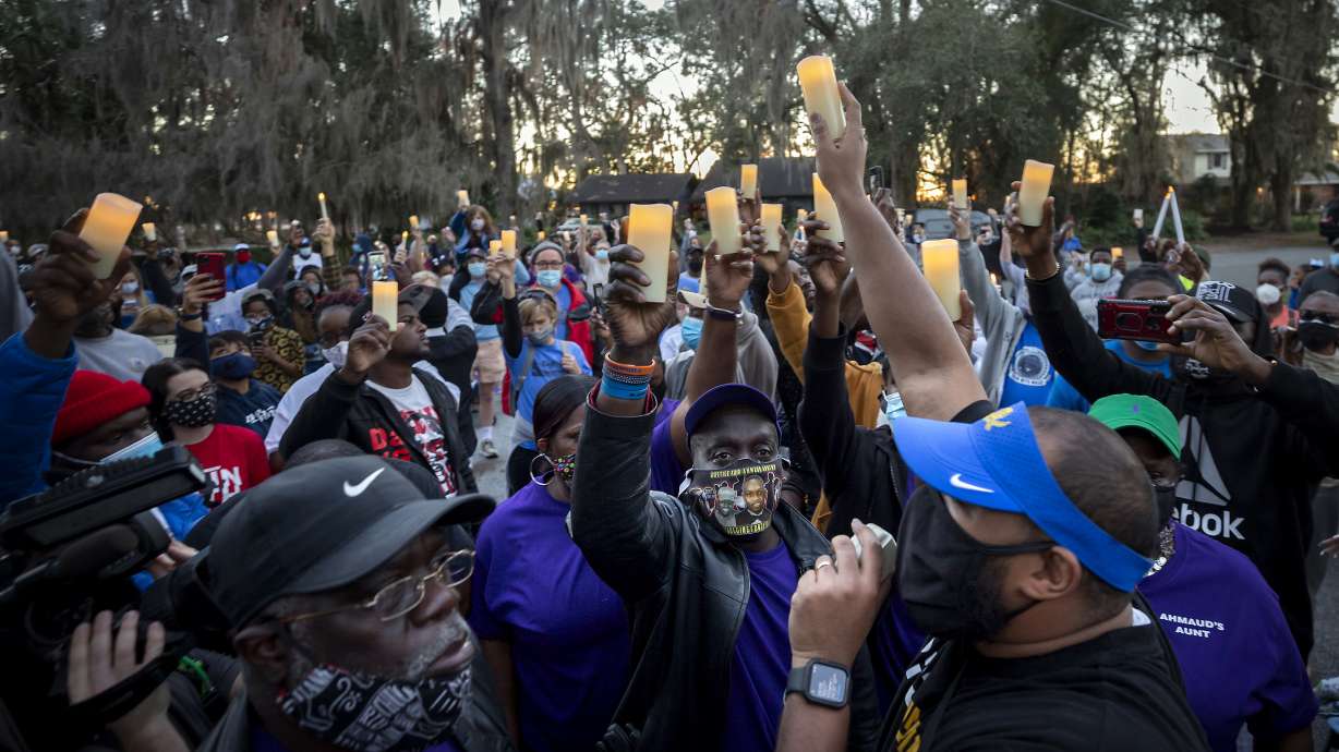 Ahmaud Arbery's father listens during a candlelight vigil for Ahmaud Feb. 23 in Brunswick, Ga. Arbery's son was shot and killed while running in a neighborhood outside the port city. Jury selection in the case is scheduled to begin Monday.