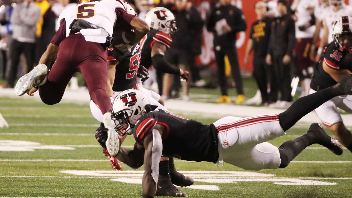 Utah Utes linebacker Devin Lloyd (0) makes a tackle on Arizona State Sun Devils quarterback Jayden Daniels (5) in Salt Lake City on Saturday, Oct. 16, 2021.