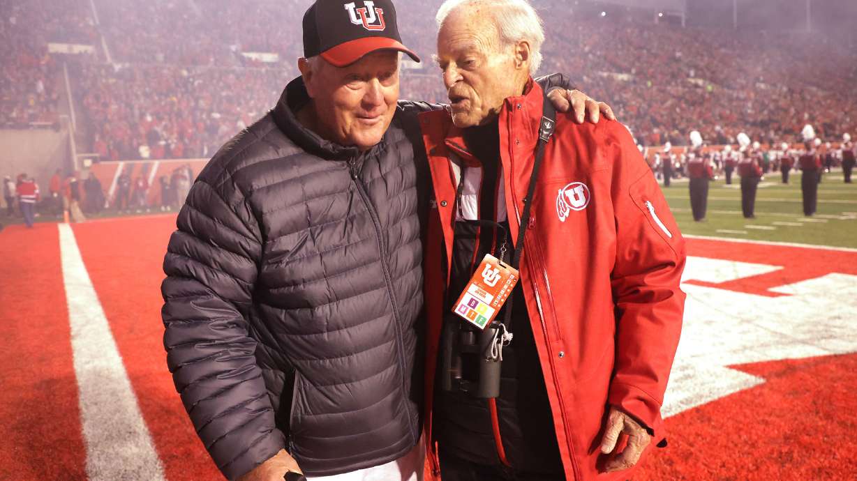 Ron McBride and Spencer Eccles talk during a University of Utah football game in Salt Lake City on Saturday, Oct. 16, 2021.