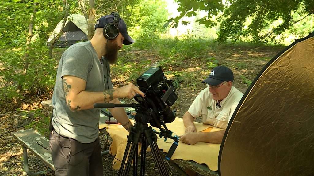 Tim Rowberry directs his father, making sure they get the proper shots for their video on how to make a paracord bracelet.