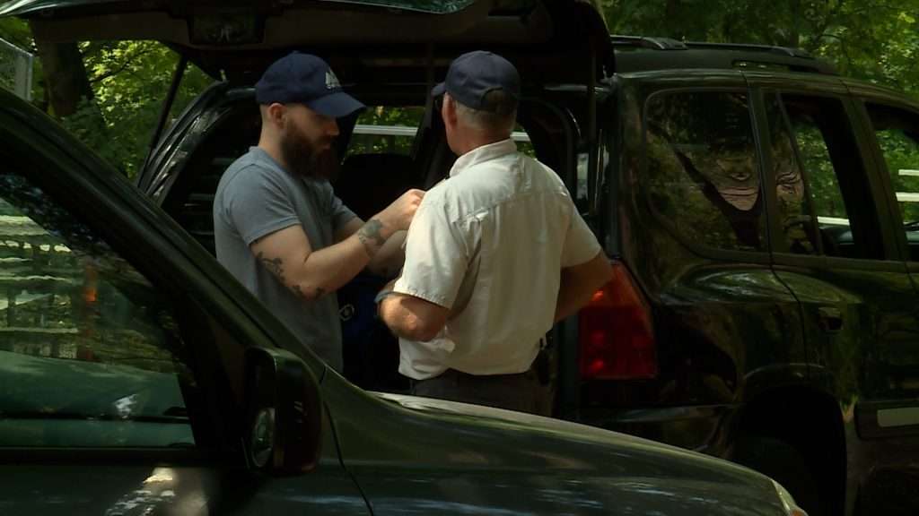 Vic Rowberry gets hooked up to a microphone before shooting a video.
