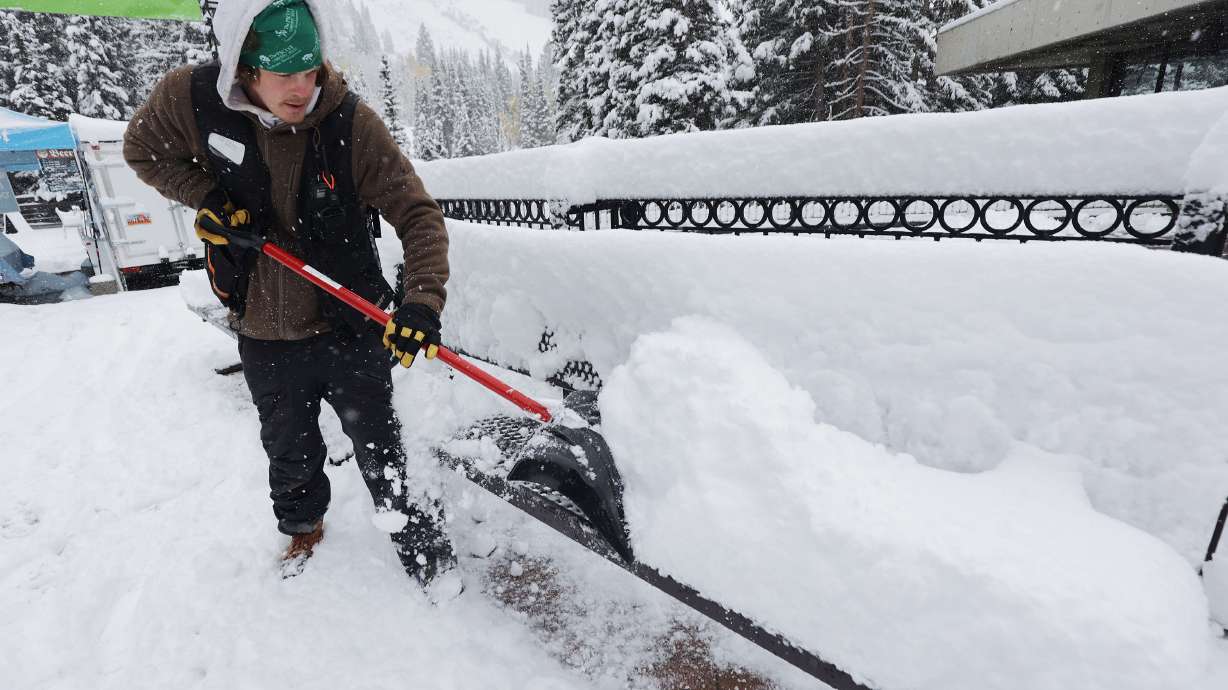 Rob Steiner clears snow from a bench at Snowbird on Tuesday, Oct. 12. Another storm arriving in Utah is expected to provide upwards of a foot of snow to Little Cottonwood Canyon Monday and Tuesday.