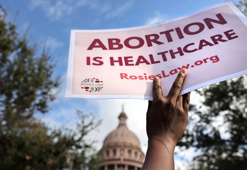  A supporter of reproductive rights holds a sign outside the Texas State Capitol building during the nationwide Women's March, held after Texas rolled out a near-total ban on abortion procedures and access to abortion-inducing medications, in Austin, Texas, on Oct. 2.