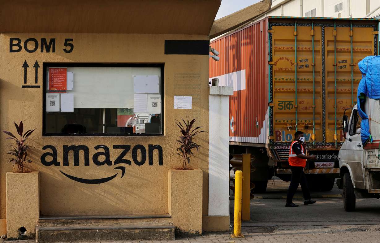 A man inspects trucks before they enter an Amazon storage facility on the outskirts of Mumbai, India, October 1, 2021. Five members of the U.S. House Judiciary committee wrote to Amazon's chief executive Sunday, and accused the company's top executives, including founder Jeff Bezos, of either misleading Congress or possibly lying to it about Amazon's business practices.