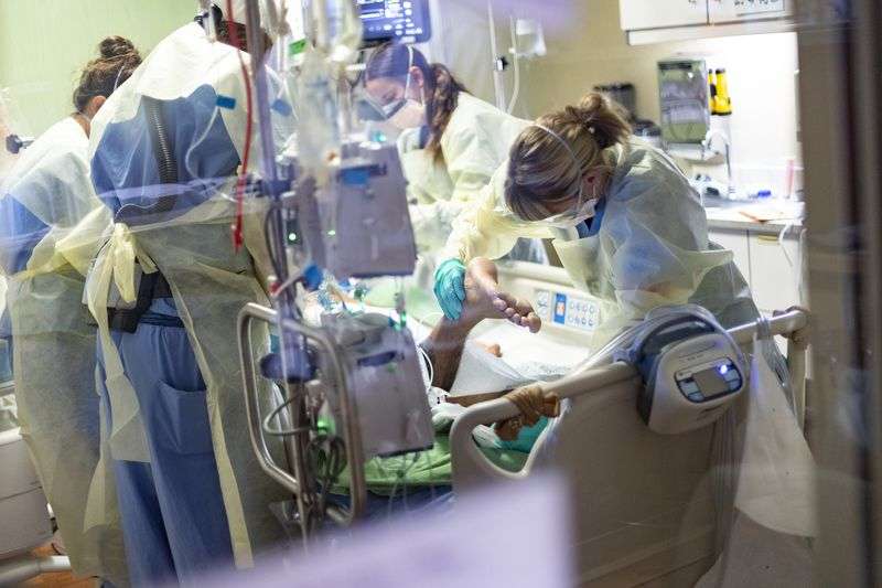 Medical professionals pronate a 39-year-old unvaccinated COVID-19 patient in the intensive care unit at St. Luke’s Boise Medical Center in
Boise on Aug. 31.