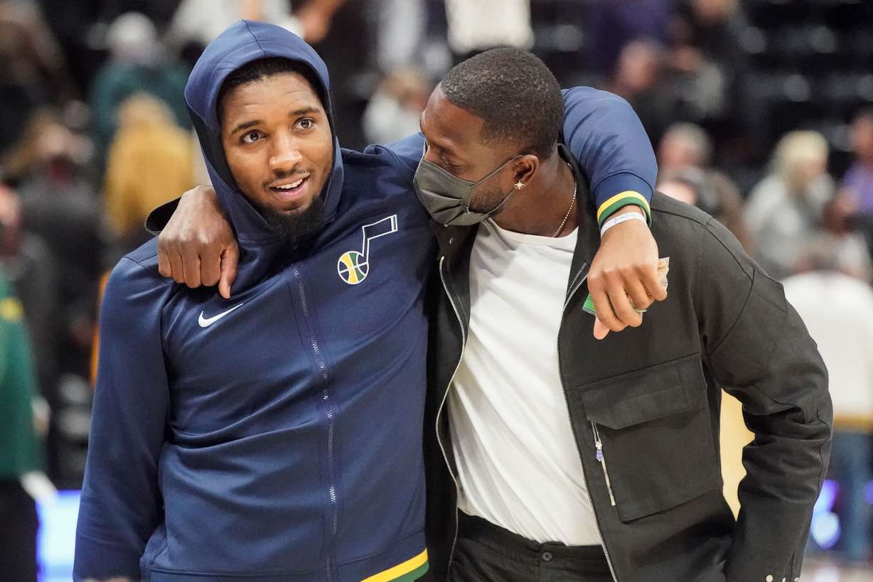 Utah Jazz guard Donovan Mitchell and Utah Jazz minority owner Dwayne Wade talk after an NBA preseason game between the Utah Jazz and the Milwaukee Bucks at Vivint Arena in Salt Lake City on Wednesday, Oct. 13, 2021.