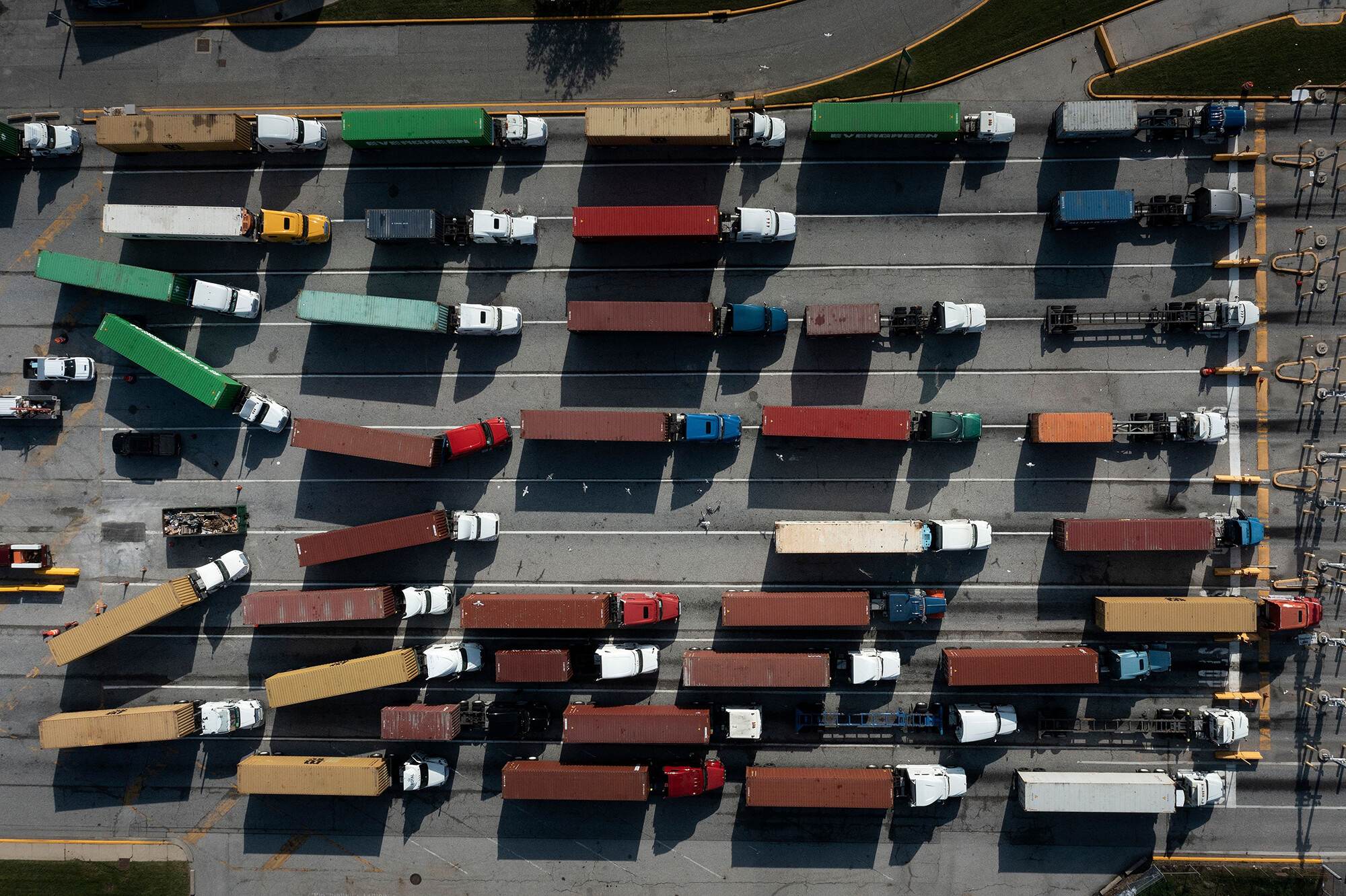 The trucking industry is short 80,000 drivers, a record high, Chris Spear, president and CEO of the American Trucking Association, tells CNN. Trucks are seen transporting cargo containers in Baltimore, Maryland, on Oct 14.