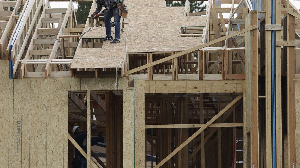 Workers toil on a multifamily dwelling Aug. 4, 2020, in Winter Park, Colo.
