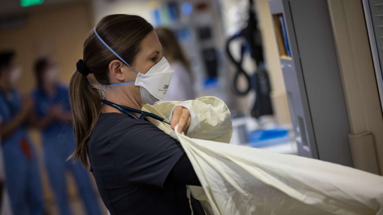 A University of Utah Health worker gets ready to treat patients in the medical intensive care unit at University of Utah Hospital on July 30.