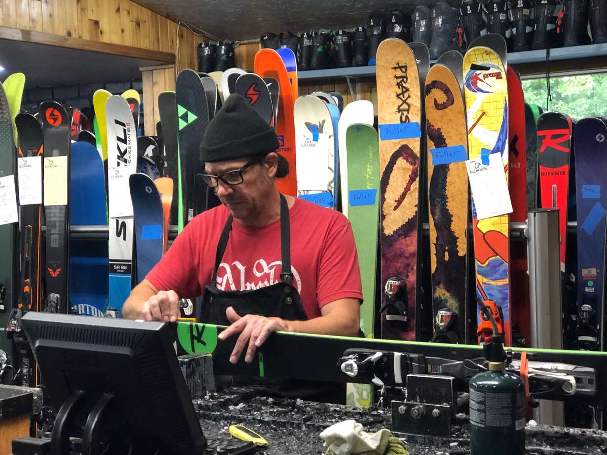 Winston Armani, a ski technician, tunes up some skis at the Lifthouse Ski Shop.