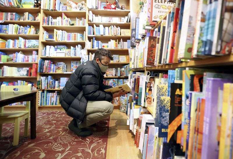Zach Galanis shops for his son’s birthday at The King’s
English Bookshop in Salt Lake City on Tuesday.