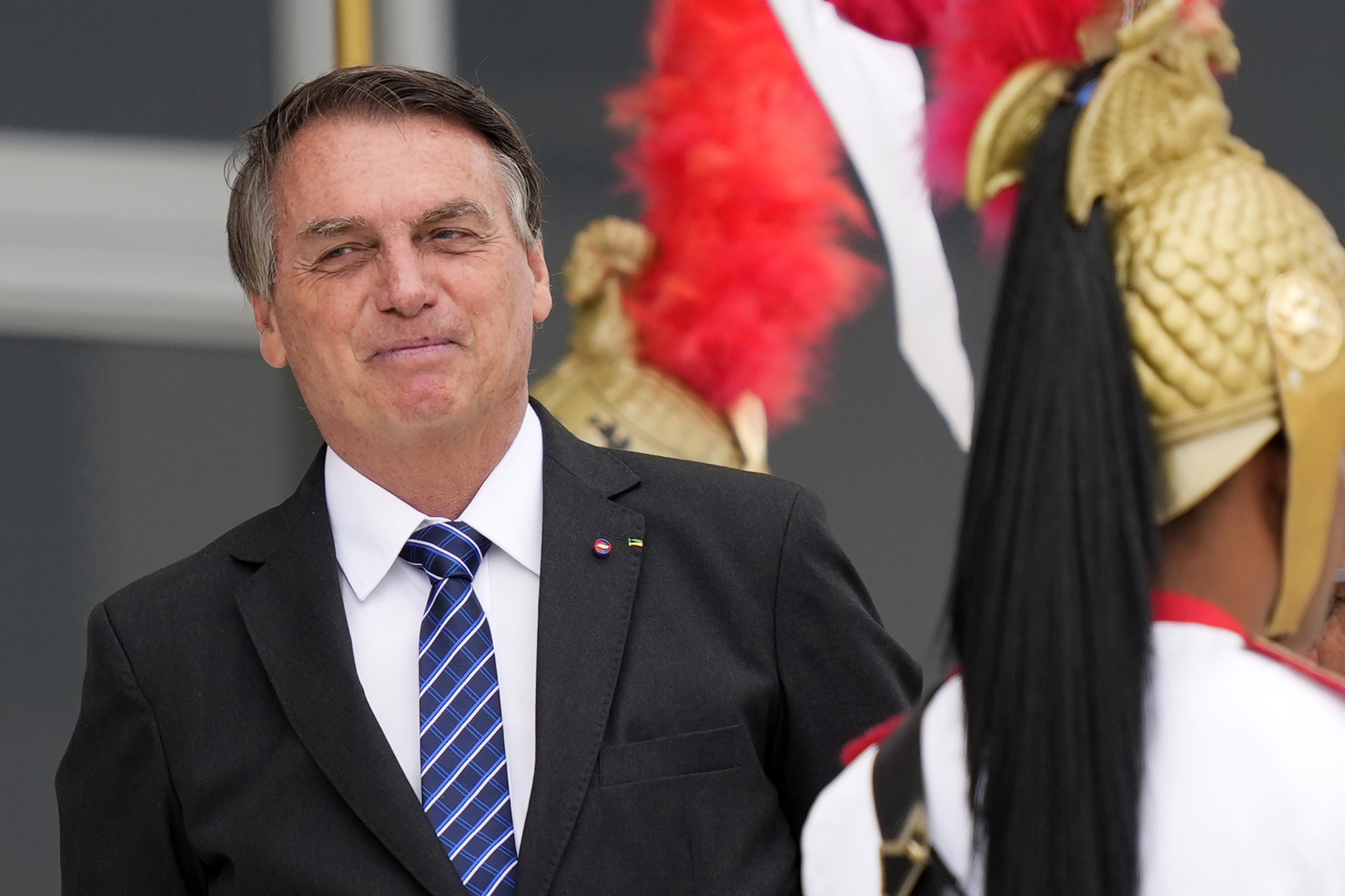 Brazilian President Jair Bolsonaro waits for the arrival of Colombia's President Ivan Duque to Planalto presidential palace in Brasilia, Brazil, Tuesday. A Brazilian senator has formally presented a report recommending Bolsonaro be indicted on criminal charges for allegedly bungling Brazil's response to the COVID-19 pandemic.