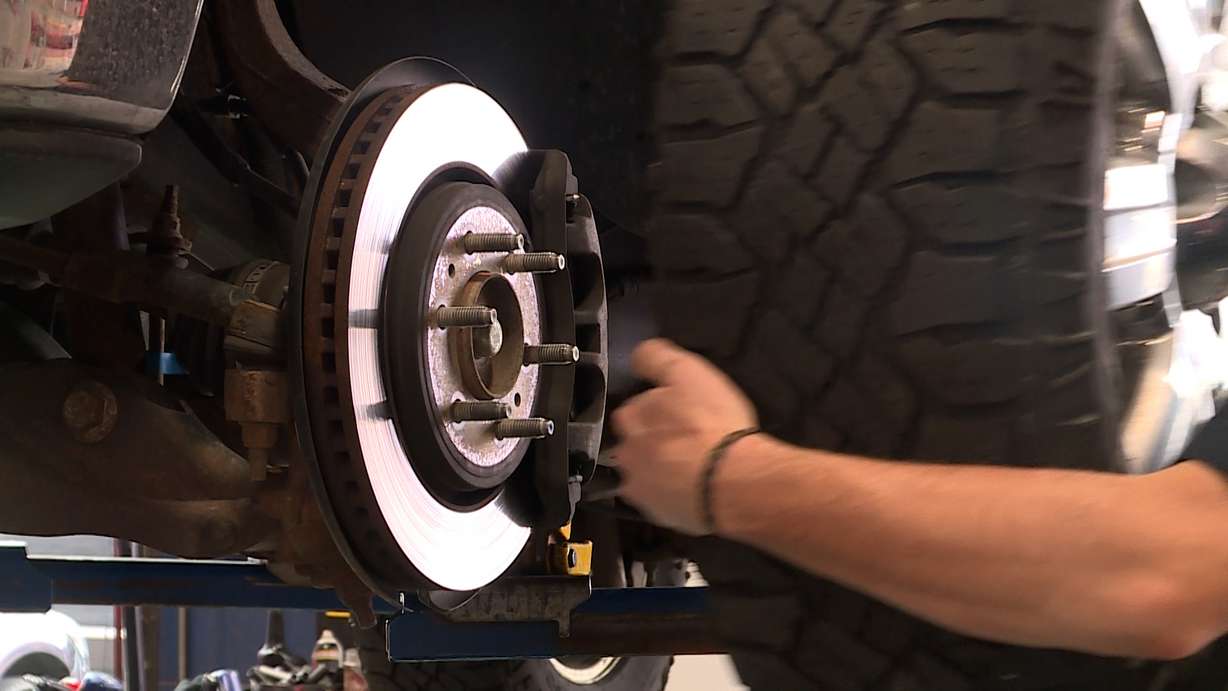 A worker puts a tire on a vehicle Tuesday. Supply chain issues for winter tires are hitting shops, which means supplies are more limited than in past years.