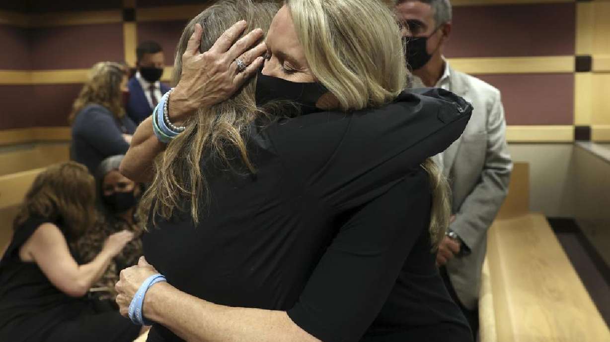 Gena Hoyer, right, hugs Debbie Hixon during a court recess following Marjory Stoneman Douglas High School shooter Nikolas Cruz's guilty plea on all 17 counts of premeditated murder and 17 counts of attempted murder in the 2018 shootings, Wednesday, at the Broward County Courthouse in Fort Lauderdale, Fla. Hoyer's son, Luke Hoyer, 15, and Hixon's husband, Christopher Hixon, 49, were both killed in the massacre.