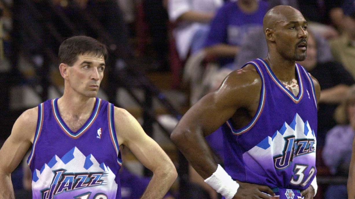 Utah Jazz's John Stockton, left, and Karl Malone watch as the Sacramento Kings walk onto the court following a time-out during the third quarter of Game 5 of the Western Conference first-round playoff series, Wednesday, April 30, 2003, in Sacramento, Calif. The Kings won 111-91, winning the series 4-1.