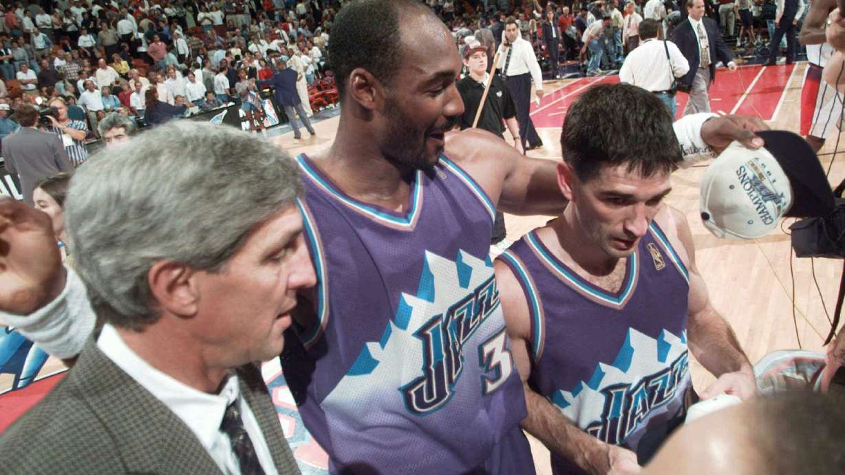 Utah Jazz's John Stockton, right, walks off the court with teammate Karl Malone, center, and coach Jerry Sloan after beating the Houston Rockets 103-100 in Game 6 of the Western Conference Finals Thursday, May 29, 1997, in Houston.