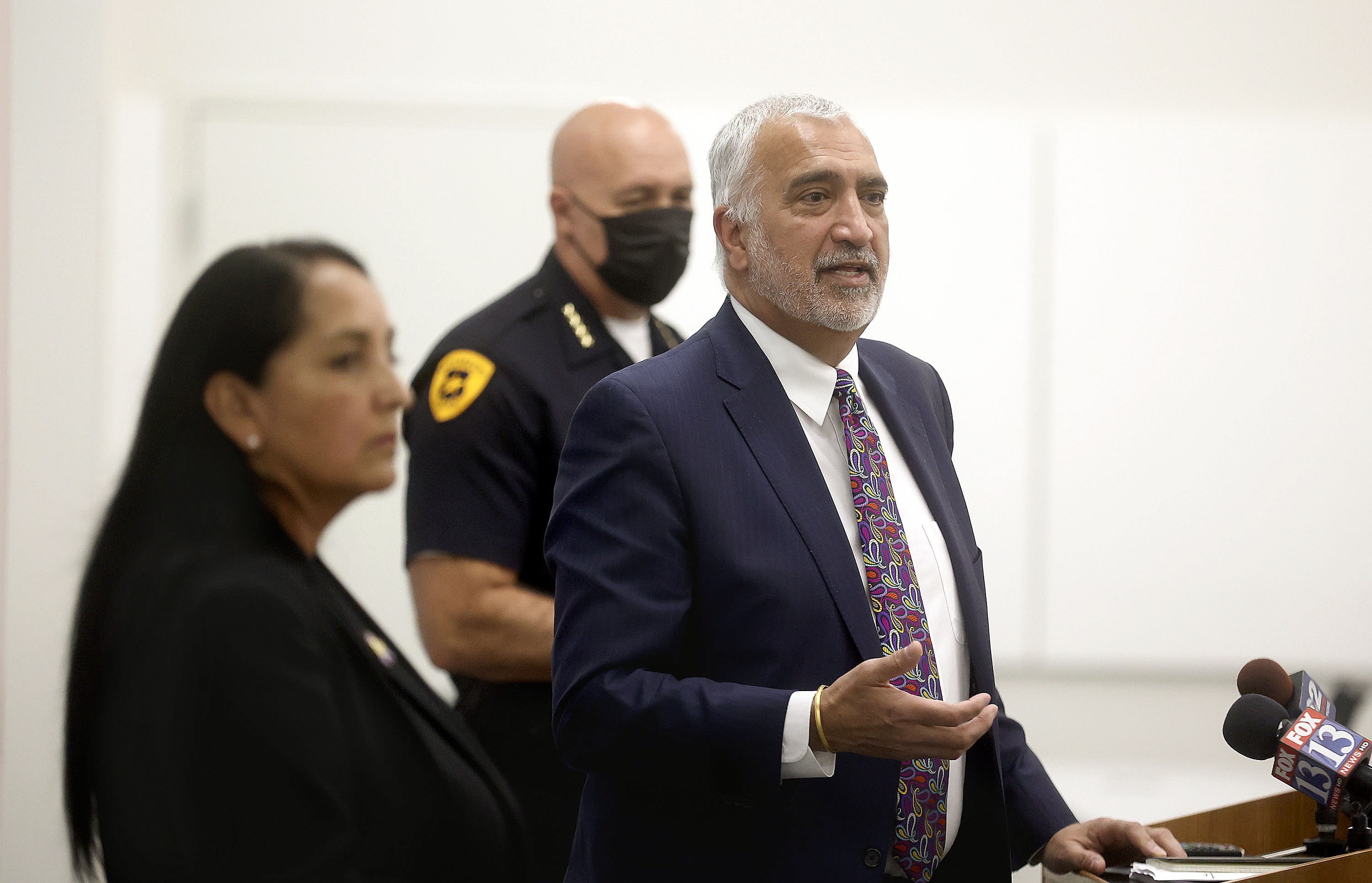 Salt Lake County District Attorney Sim Gill, right, is calling on gun owners to lock up their weapons and don't leave them unattended in cars after seeing many stolen guns used in homicides and other crimes. Salt Lake County Sheriff Rosie Rivera and Salt Lake City Police Chief Mike Brown are also pictured at a press conference on Oct. 20, 2021.