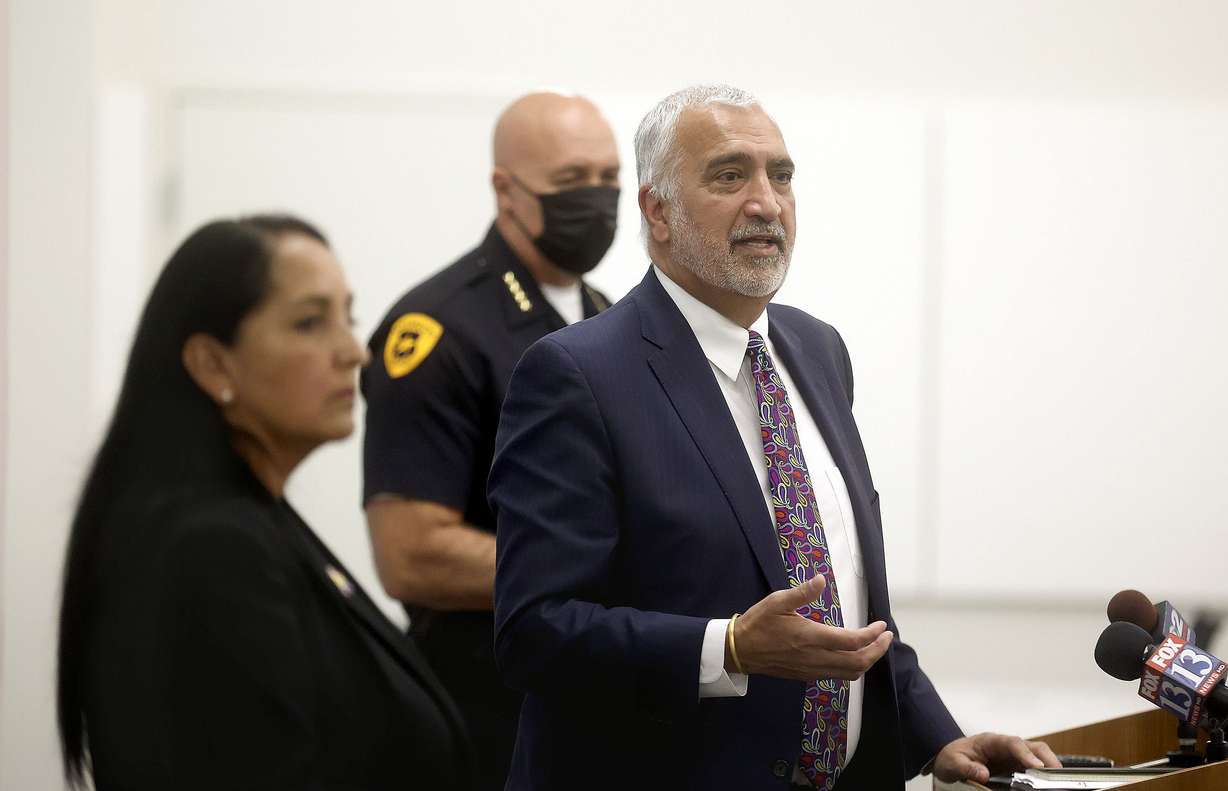 Salt Lake County Sheriff Rosie Rivera, left, and Salt Lake City Police Chief Mike Brown, center, listen as Salt Lake County District Attorney Sim Gill speaks at a press conference at the Salt Lake County District Attorney's Office building in Salt Lake City on Wednesday about a joint effort to reduce gun-related violence by no longer accepting plea bargains for gun-related crimes.