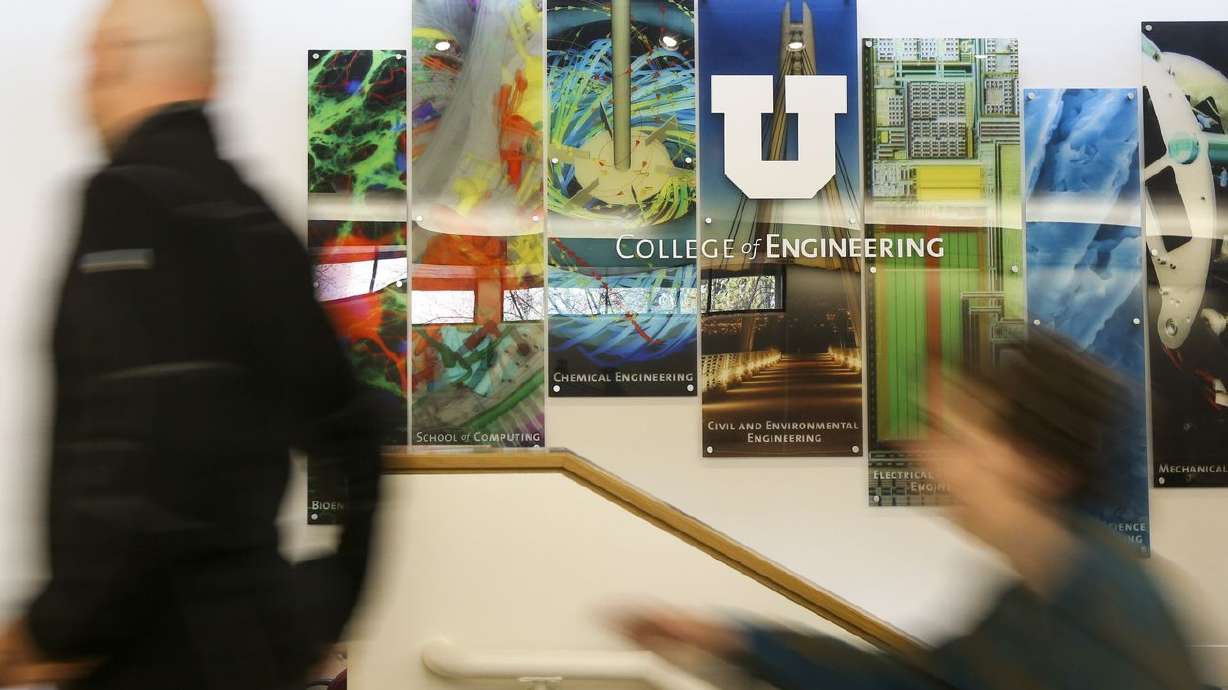A father and son walk past a College of
Engineering at the University of Utah sign during the
university’s annual Engineering Day event on campus in Salt Lake
City, Nov. 23, 2019.