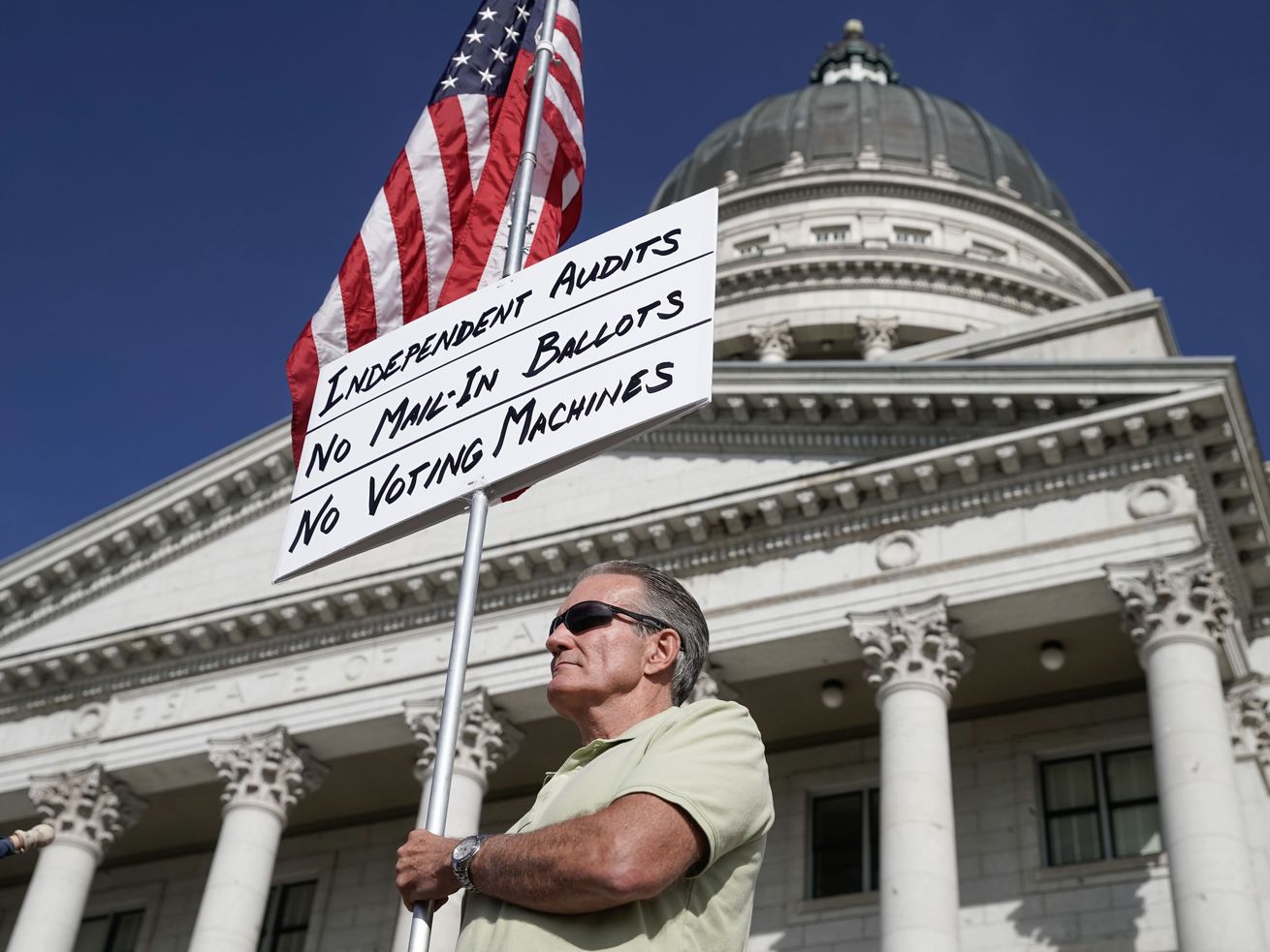 Kevin Unsinn, from Moab, holds a sign in support of a forensic vote audit during an election rally at the Capitol in Salt
Lake City on Wednesday.