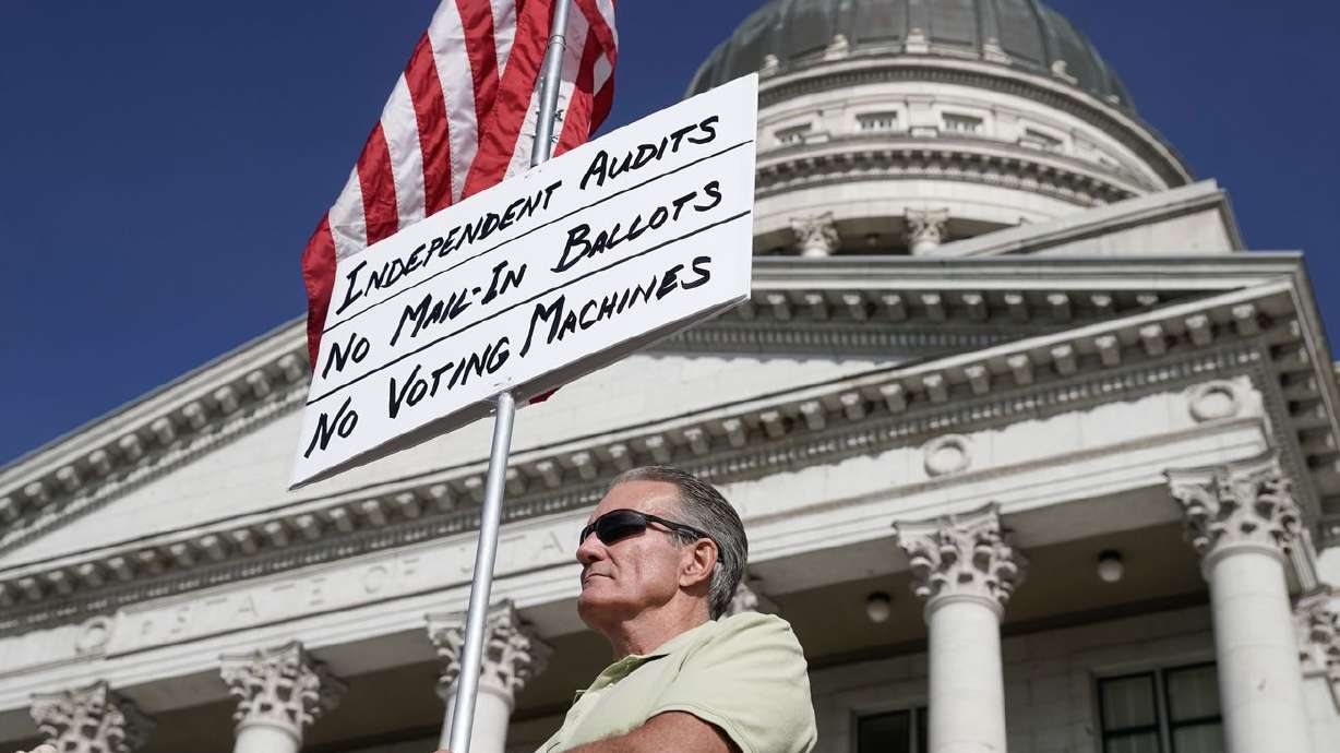 Kevin Unsinn, from Moab, holds a sign in support of a forensic vote audit during an election rally at the Capitol in Salt
Lake City on Wednesday.