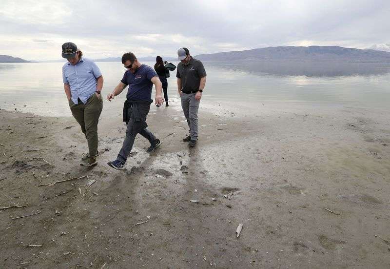 Vineyard city officials walk on Jake Holdaway’s
property on Utah Lake in Vineyard on Thursday, Oct. 7,
2021.