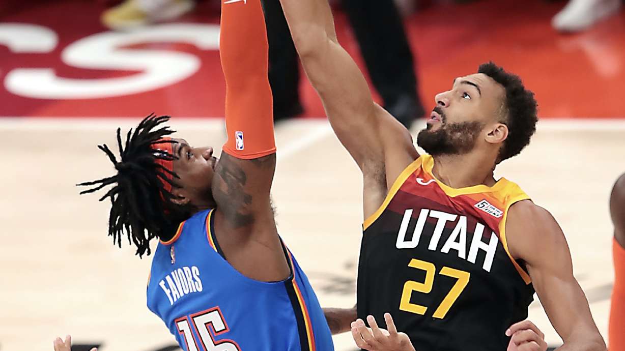 Oklahoma City Thunder center Derrick Favors (15) and Utah Jazz center Rudy Gobert (27) tip off the game as the Utah Jazz and the Oklahoma City Thunder open the 2021-22 season at Vivint Arena in Salt Lake City on Wednesday, Oct. 20, 2021.