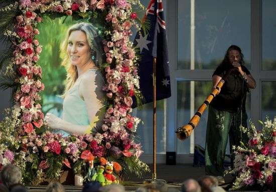 Johanna Morrow plays the didgeridoo during a memorial service for Justine Ruszczyk Damond at Lake Harriet in Minneapolis, Aug. 11. 2017. The Minneapolis police officer who fatally shot Damond, an unarmed woman, after she called 911 to report a possible rape happening behind her home was sentenced Thursday to nearly five years in prison.