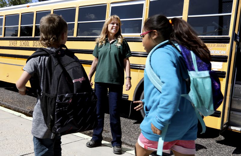 Bus driver Dawn Bittner, center, watches out for students
who take her school bus home at Monroe Elementary School in Monroe,
Sevier County, on Sept. 29.