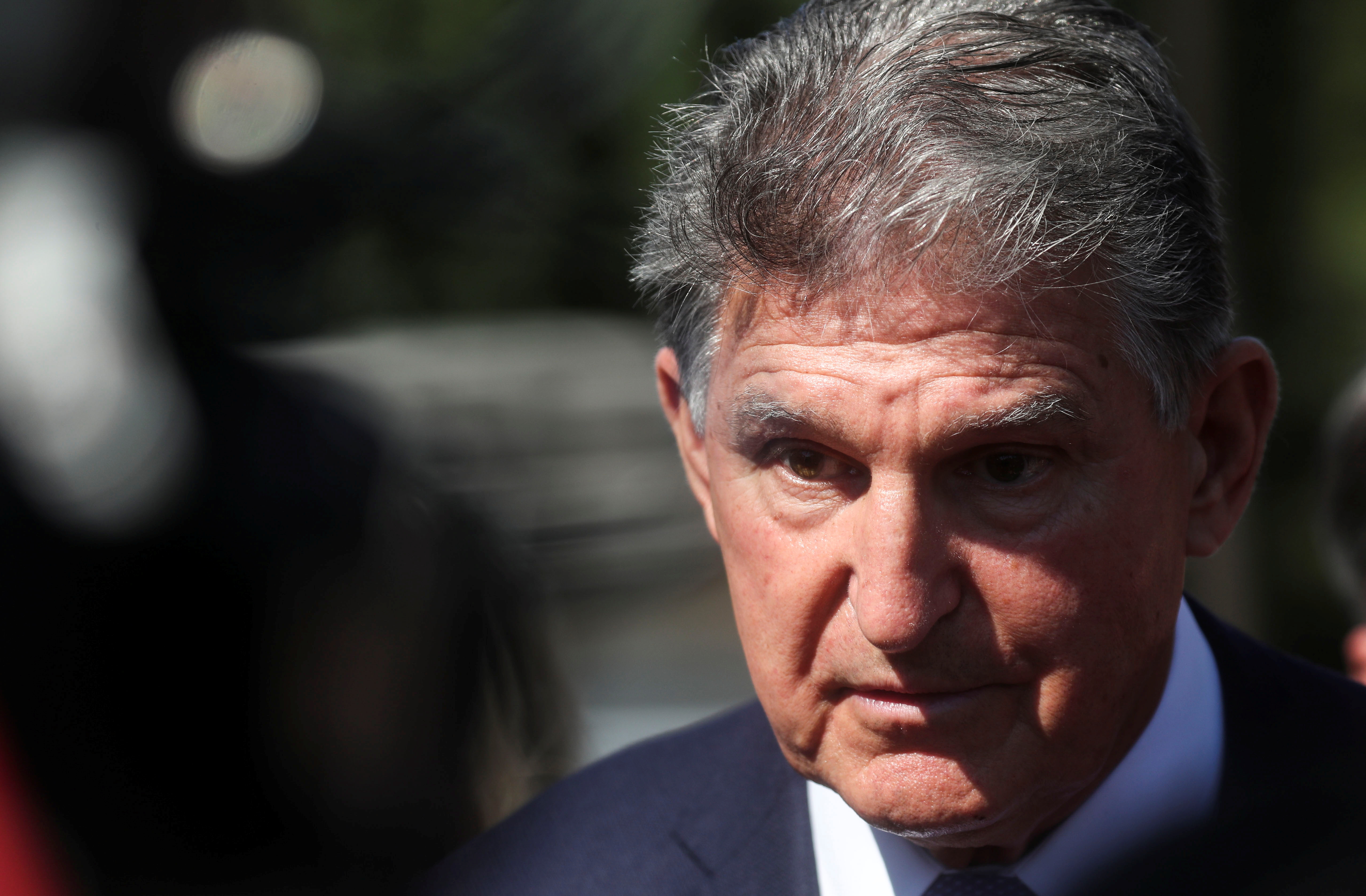 Sen. Joe Manchin, D-W.V., faces reporters outside the U.S. Capitol in Washington, Sept. 30. Manchin said on Thursday that Democrats in Congress are not going to reach an agreement "anytime soon" on the broad outlines of President Joe Biden's ambitious expansion of social programs.
