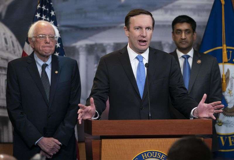 Sen. Bernie Sanders, I-Vt., left, and Rep. Ro Khanna,
D-Calif., right, listen as Sen. Chris Murphy, D-Conn., speaks to
reporters on Capitol Hill in Washington, April 4,
2019.