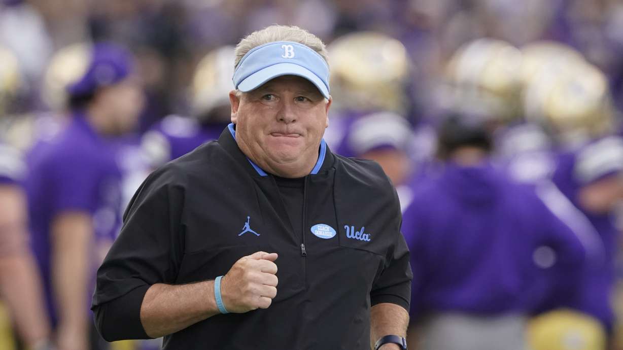 UCLA head coach Chip Kelly runs on the field before the team's NCAA college football game against Washington, Saturday, Oct. 16, 2021, in Seattle.
