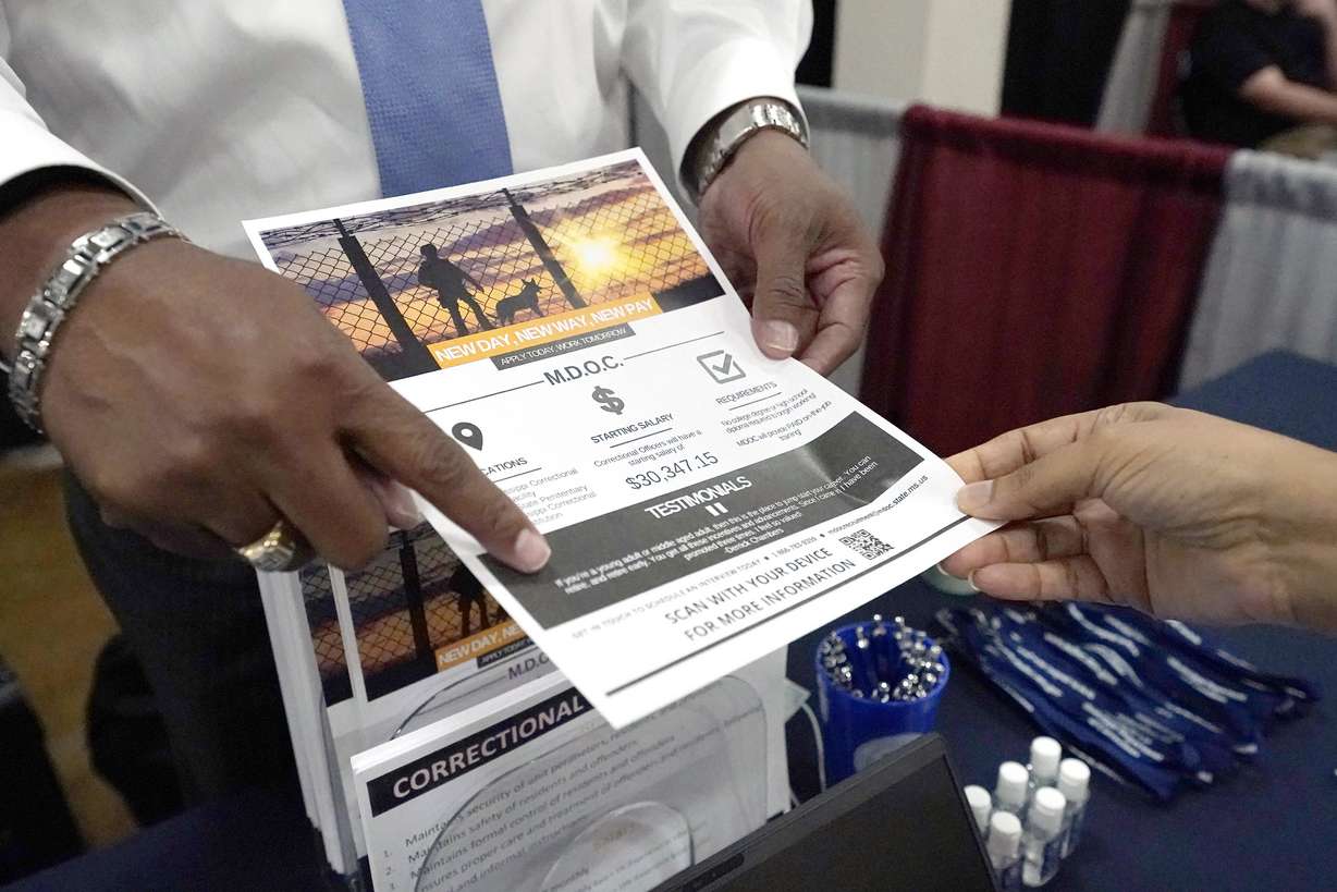Curtis McCray, a Mississippi Department of Corrections recruiter, left, points out a positive testimonial to a job applicant during the Lee County Area Job Fair in Tupelo, Miss., Oct. 12. Employers representing a variety of manufacturing, production, service industry, medical and clerical companies attended the daylong affair with an eye towards recruitment, hiring, training and retention.