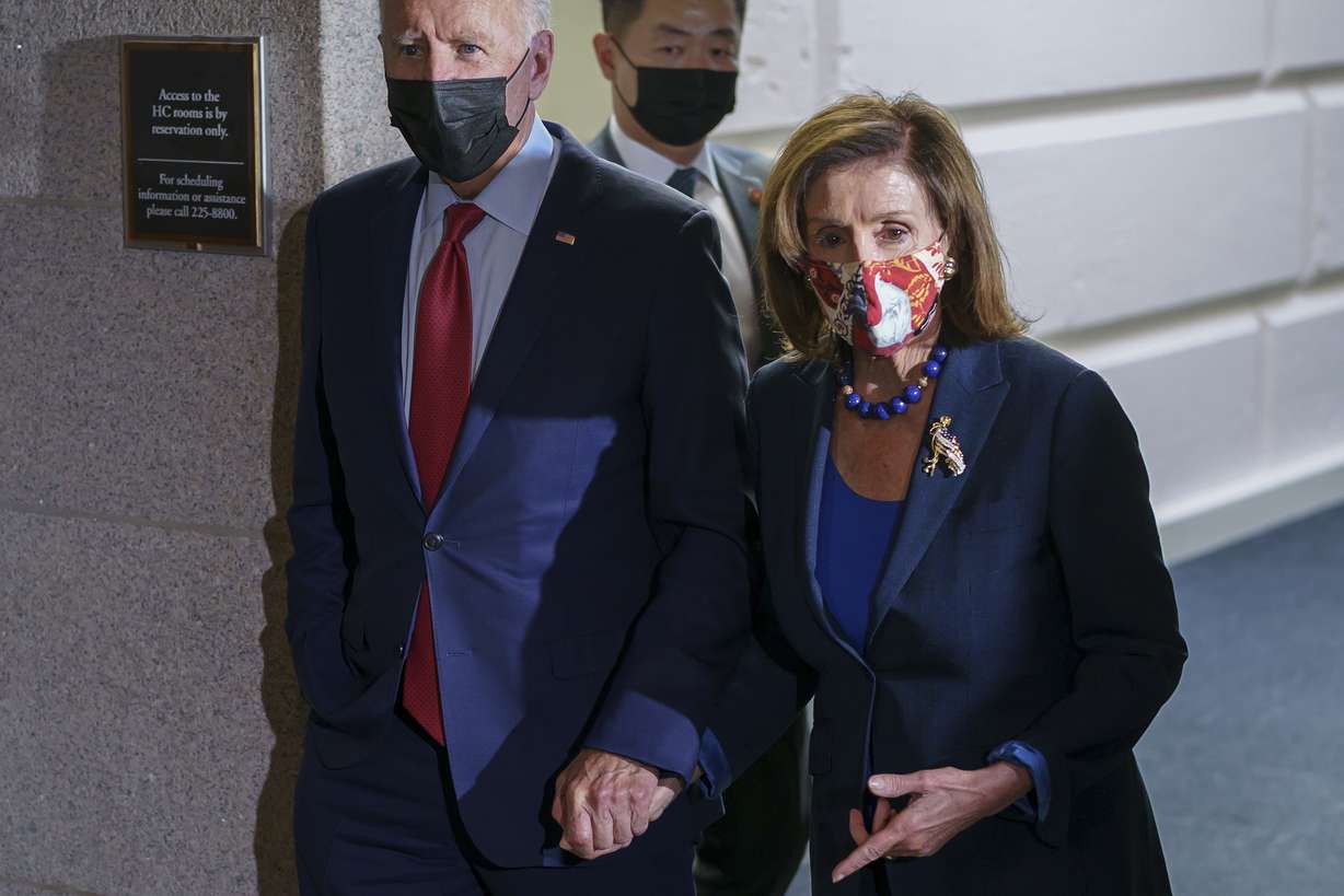 President Joe Biden and Speaker of the House Nancy Pelosi, D-Calif., walk in a basement hallway of the Capitol after meeting with House Democrats, on Capitol Hill in Washington on Oct. 1.