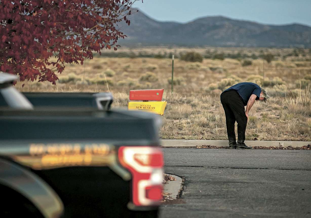 A distraught Alec Baldwin lingers in the parking lot outside the Santa Fe County Sheriff's Office in Santa Fe, N.M., after he was questioned about a shooting on the set of the film "Rust" on the outskirts of Santa Fe, Thursday.