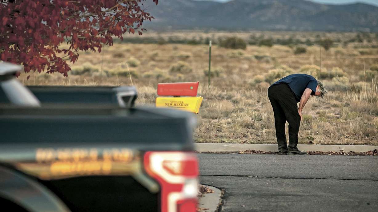 A distraught Alec Baldwin lingers in the parking lot outside the Santa Fe County Sheriff's Office in Santa Fe, N.M., after he was questioned about a shooting on the set of the film "Rust" on the outskirts of Santa Fe, Thursday. Baldwin fired a prop gun on the set, killing cinematographer Halyna Hutchins and wounding director Joel Souza, officials said.